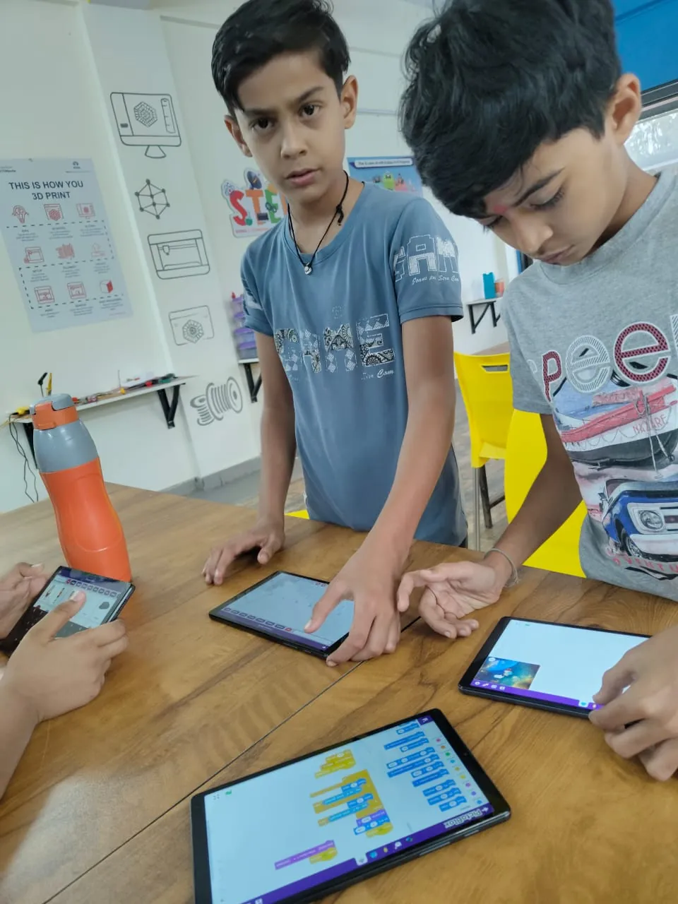 Students coding on tablets